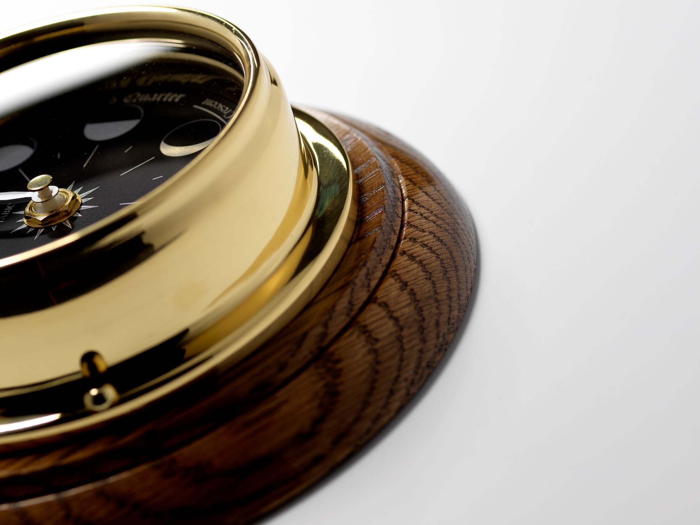 Prestige Brass Moon Phase Clock With a Jet Black Dial Mounted on a Solid English Dark Oak Wall Mount - TABIC CLOCKS