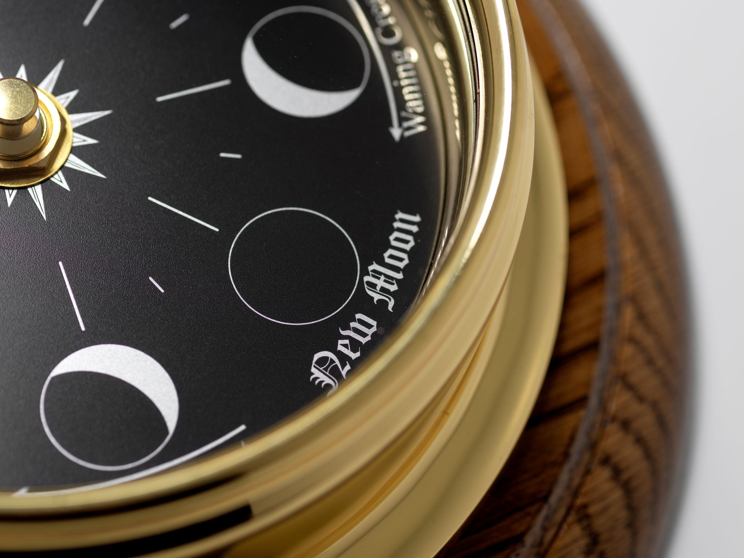 Prestige Brass Moon Phase Clock With a Jet Black Dial Mounted on a Solid English Dark Oak Wall Mount - TABIC CLOCKS