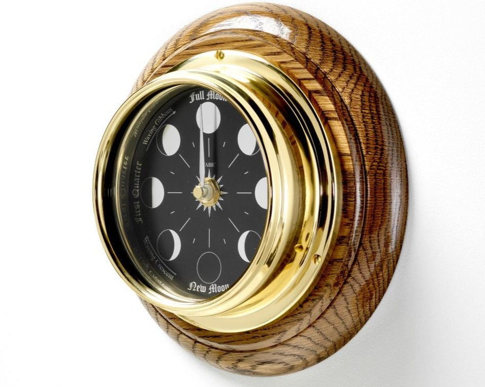 Prestige Brass Moon Phase Clock With a Jet Black Dial Mounted on a Solid English Dark Oak Wall Mount - TABIC CLOCKS